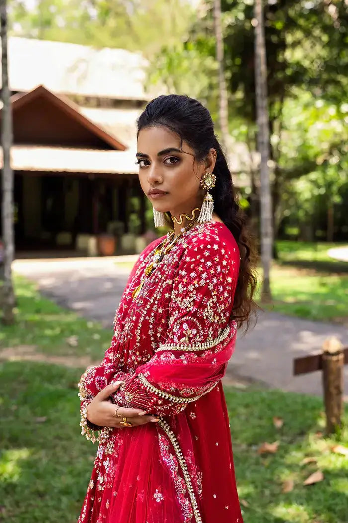 Close-up of GOLNAR-SRF25-01 Saira Rizwan Sharara showcasing detailed embroidery and premium tailoring on red Korean raw silk fabric.