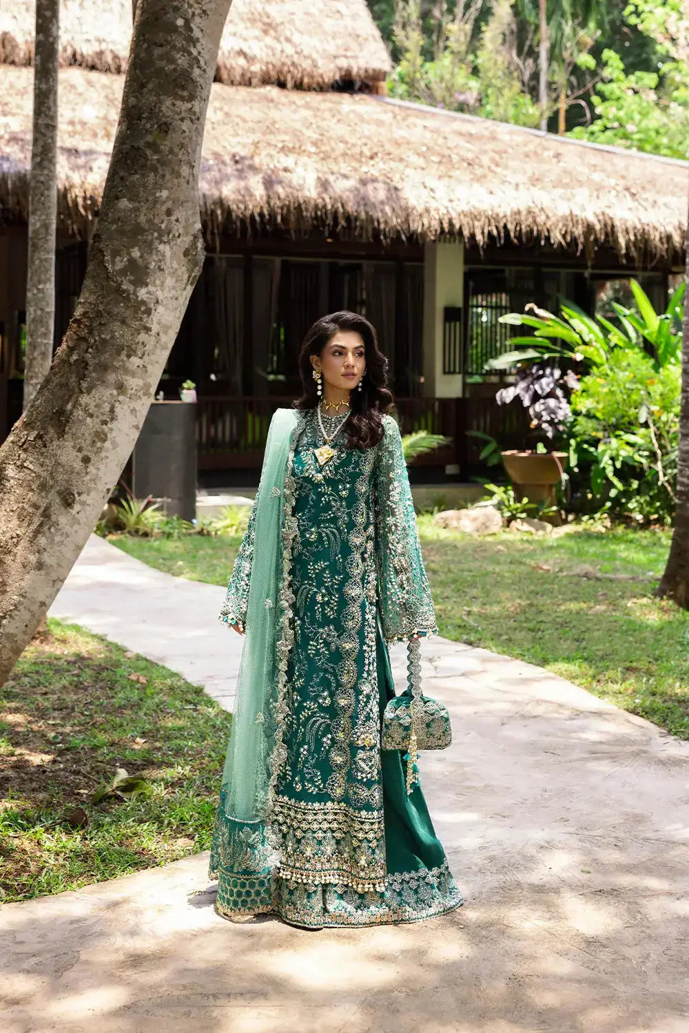 KIANA-SRF25-04 by Saira Rizwan in green with floral embroidery and hand embellishments, styled with matching accessories for formal wear.