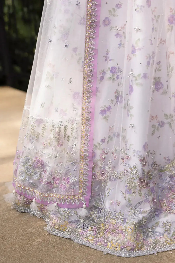 Close-up of ELINA-SRF25-05 hemline showcasing detailed beadwork, sequins, and pastel floral embroidery on sheer net fabric.