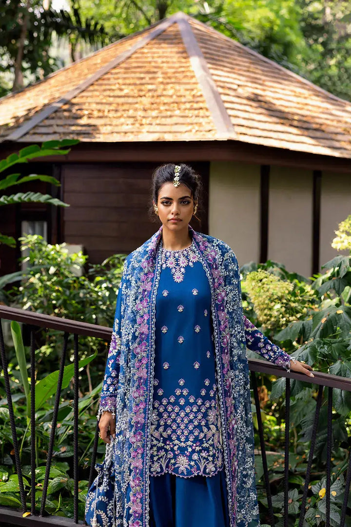 Model wearing DELARA-SRF25-08 royal blue embroidered silk suit with matching dupatta by SAIRA RIZWAN LUXURY, styled for formal elegance.