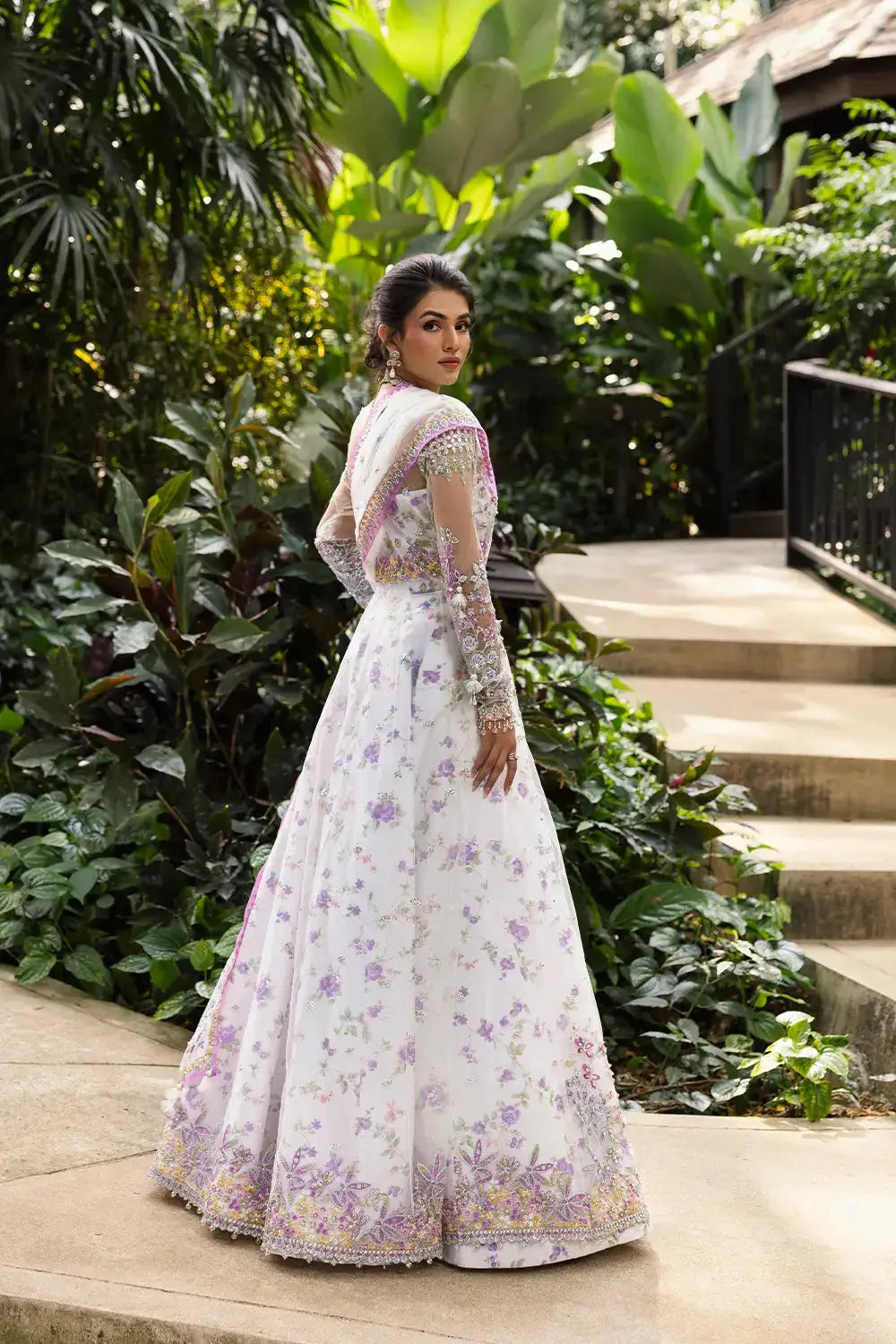 Back view of ELINA-SRF25-05 SAIRA RIZWAN EXCLUSIVE stitched net outfit with lavender floral motifs and embellished raw silk fabric.