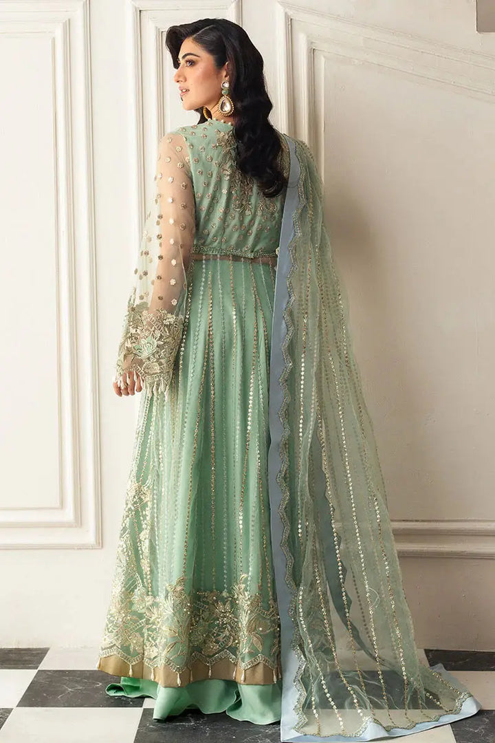 Back view of MUSHQ Green Pistachio Dress showcasing embroidered hem, sheer sleeves, and flowing dupatta in formal wear collection.