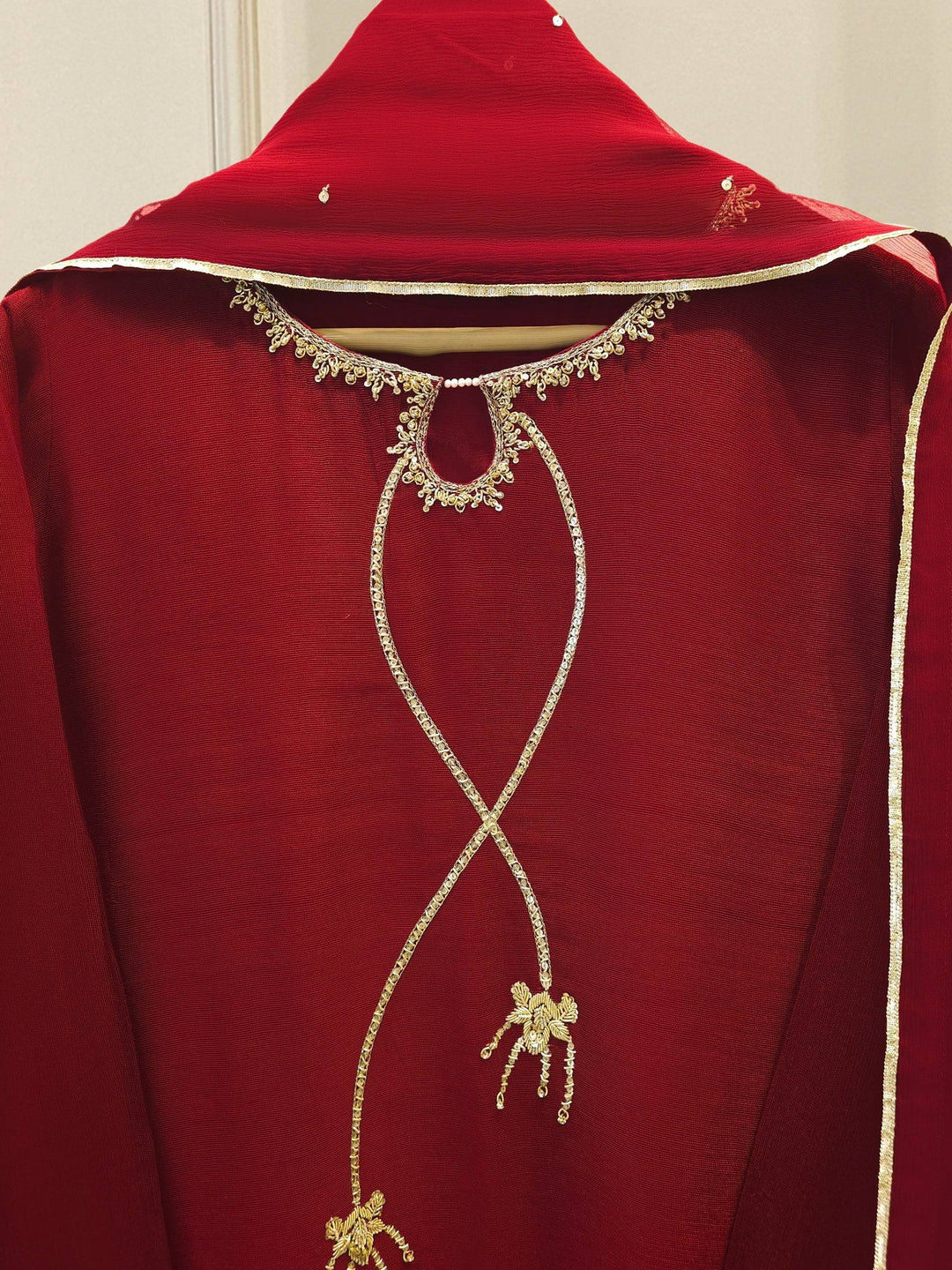 Close-up of neckline embroidery on AGHA NOOR 3 Piece Suit, highlighting intricate gold threadwork and bow detailing on cotton net fabric.