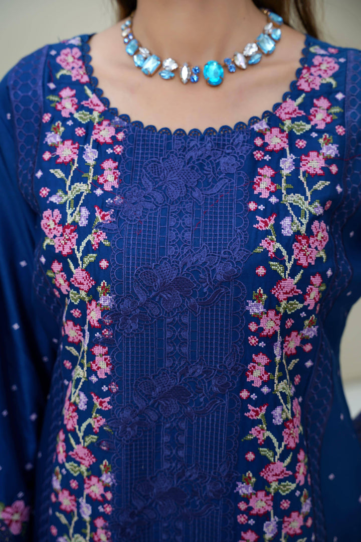 Close-up of neckline embroidery on RANGREZA SAJNI RS-3518-1000 showcasing intricate floral patterns on blue festive Pakistani dress.