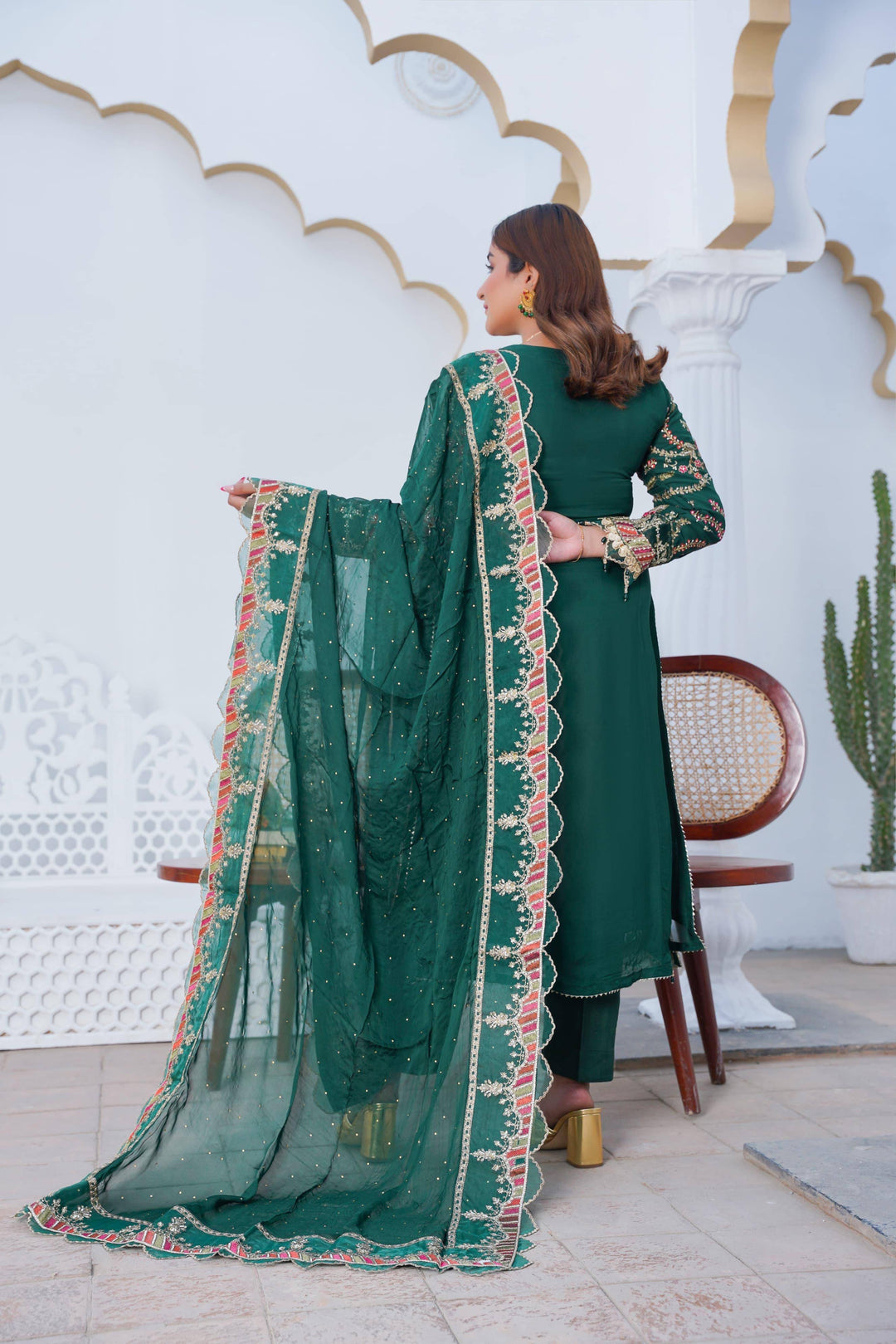 Back view of RANGREZA SAJNI Pakistani festive outfit showcasing embroidered dupatta and solid green shirt design.