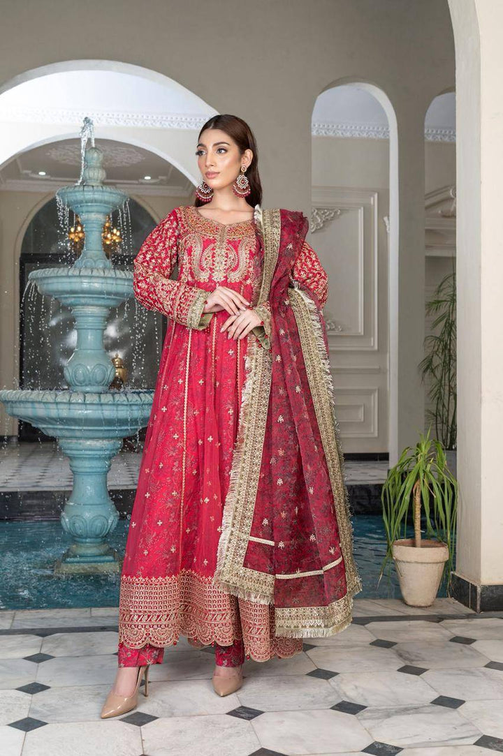 RANGREZA SAJNI - Pakistani Outfits | Pink Long Frock Set featuring intricate embroidery, paired with grip trousers and organza dupatta in a festive setting.