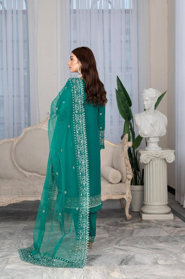 Back view of Rangreza Sajni embroidered green lawn outfit with matching dupatta, showcasing elegant Pakistani fashion design.