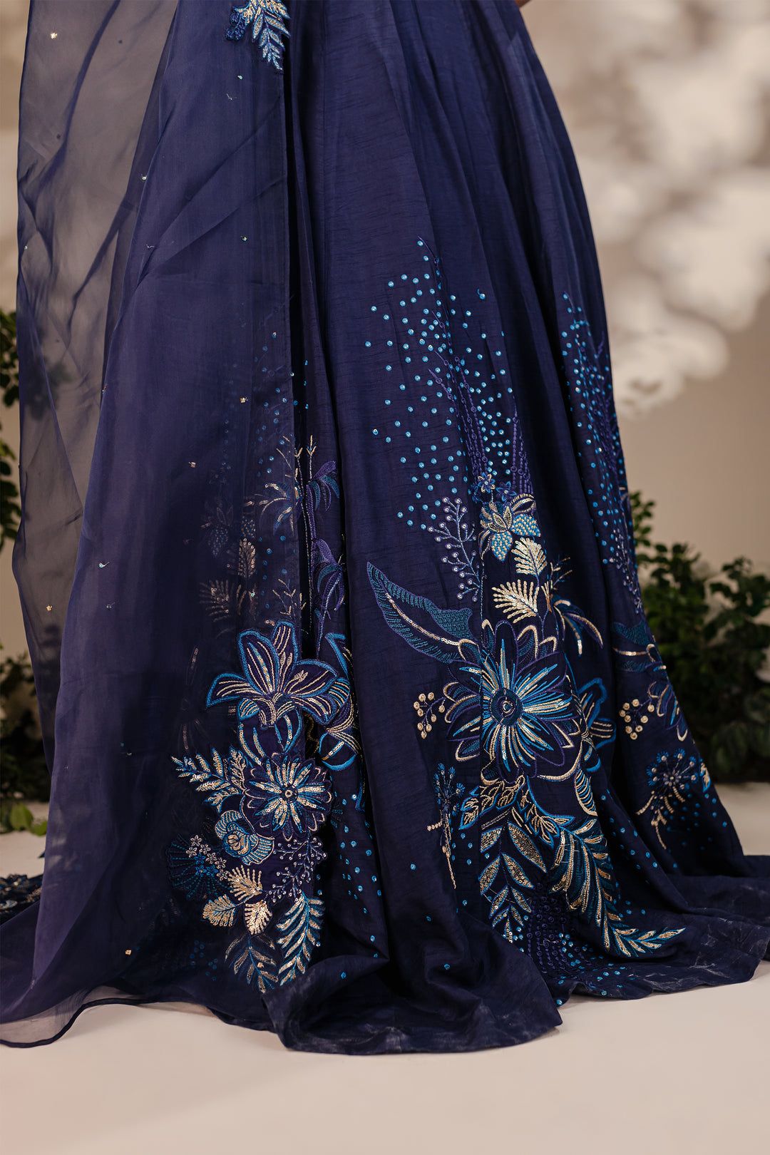 Detailed embroidery on Batik Arden 3 Piece lehnga in navy raw silk with gold and blue floral patterns and beaded accents.