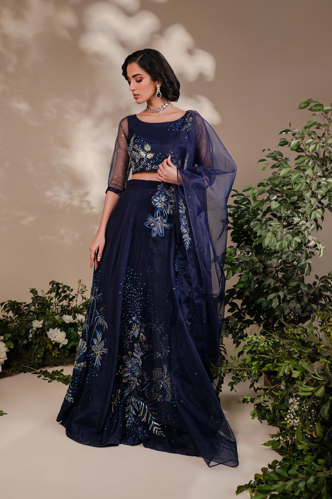 Model wearing Batik Arden 3 Piece dress with detailed floral embroidery in blue and gold on raw silk lehnga and organza choli.