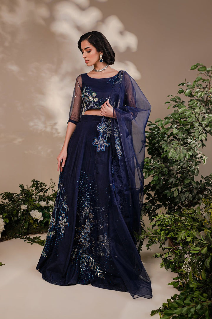 Model wearing Batik Arden 3 Piece dress with detailed floral embroidery in blue and gold on raw silk lehnga and organza choli.