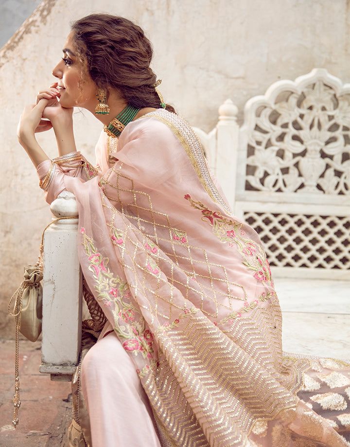Faiza Saqlain Gulfam outfit styled with traditional accessories, featuring embroidered organza dupatta and raw silk fabric.