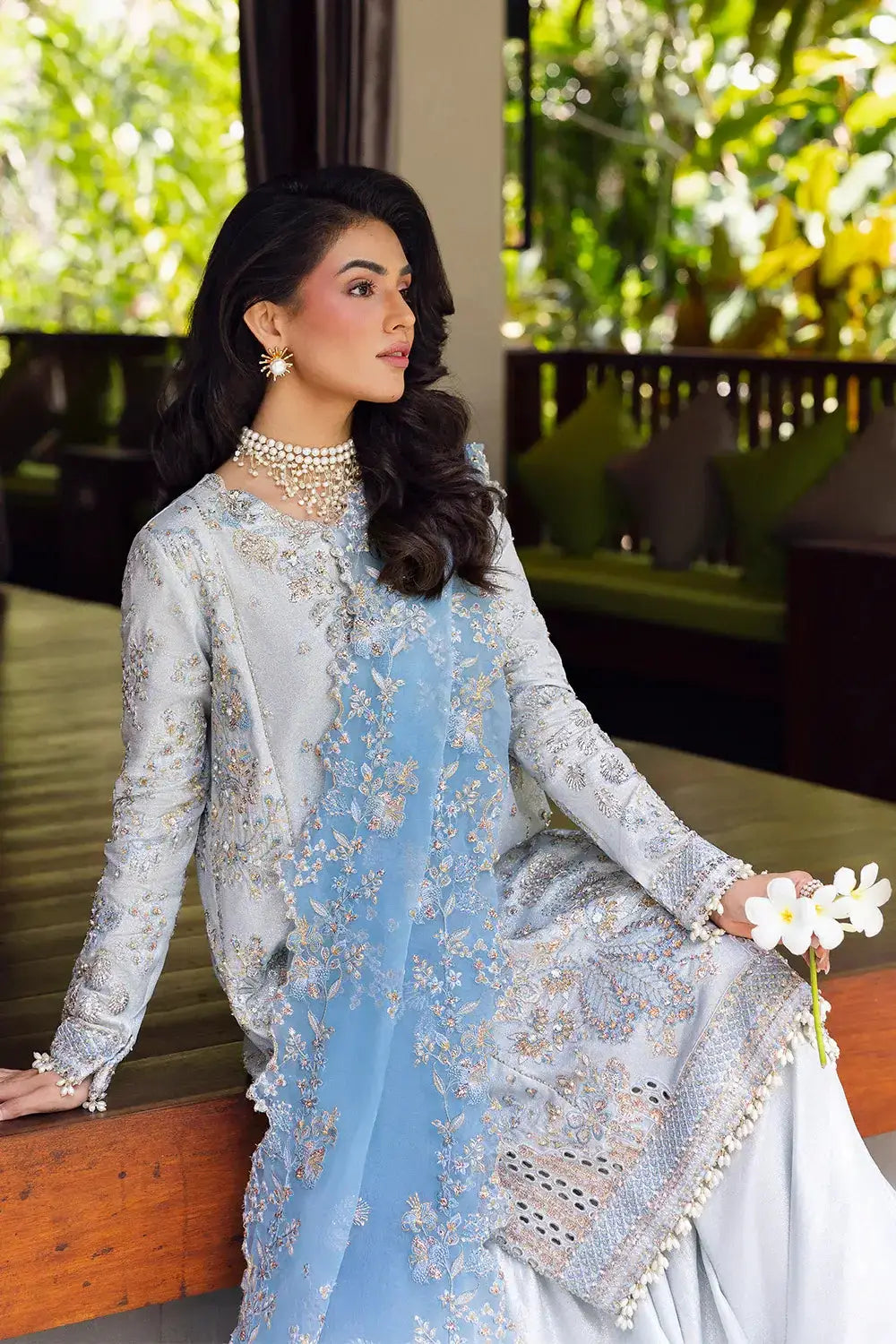 Elegant seated pose in Saira Rizwan's SORAYA-SRF25-06 stitched outfit, highlighting floral embroidery and organza dupatta.
