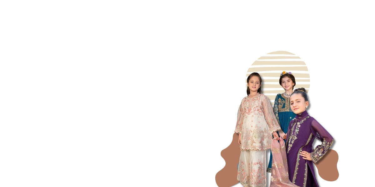 Three women in traditional outfits standing in front of a cardboard cutout of a building.