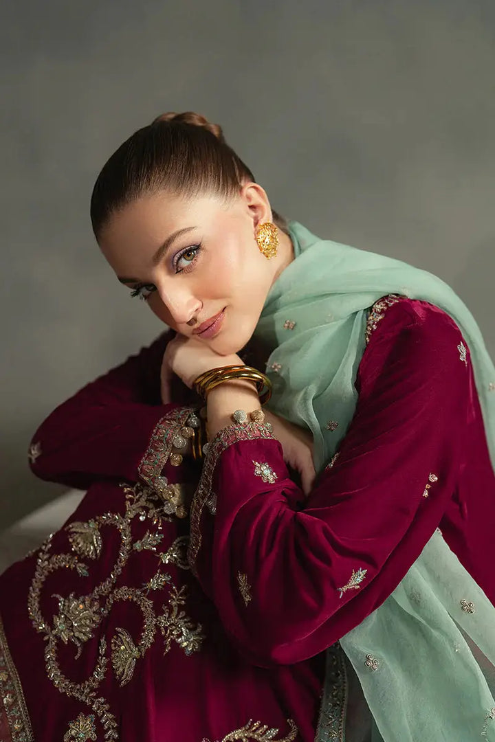 Model posing in MUSHQ Velvet - Ruby Maroon Shirt Set with gold embroidery and mint dupatta, exuding elegance and festive charm.