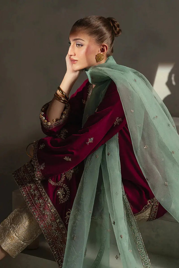 Model in MUSHQ Velvet - Ruby Maroon Shirt Set sitting in soft lighting, highlighting the texture of velvet and shimmer of embroidery.