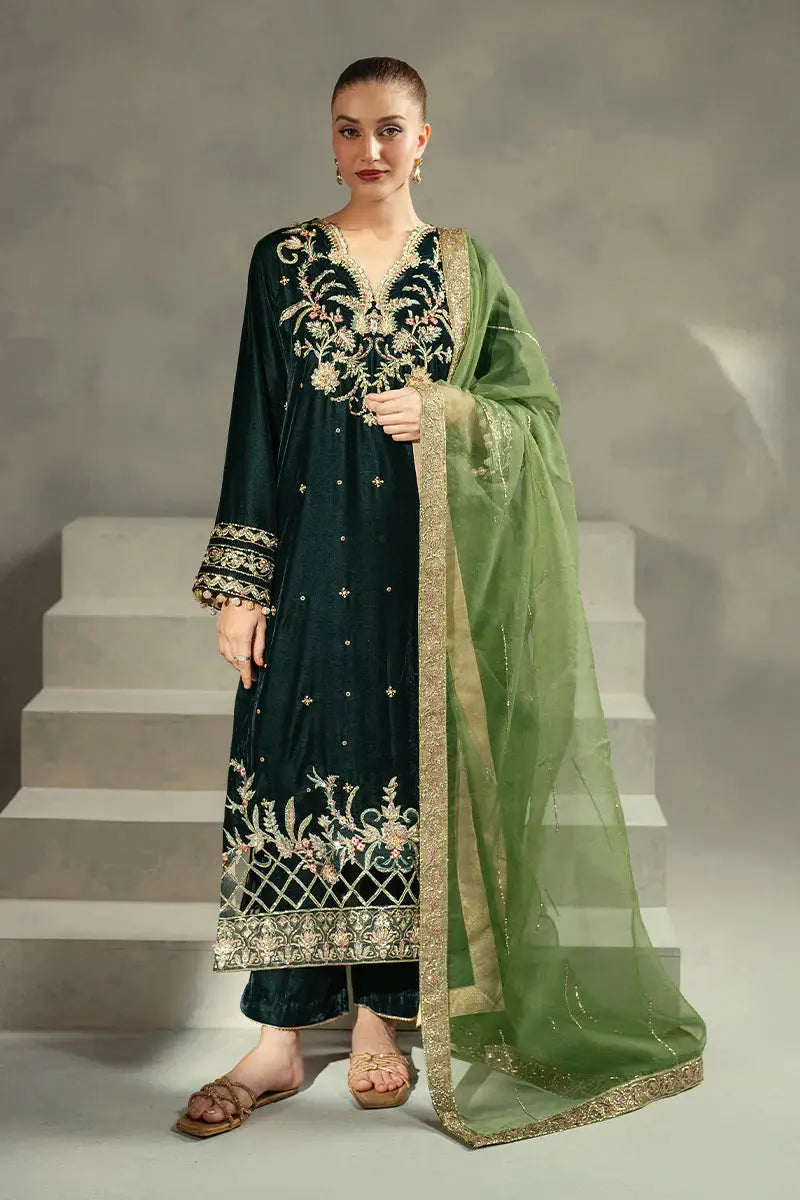MUSHQ Ayren green velvet outfit featuring an embroidered shirt, matching trousers, and a sheer dupatta with gold detailing for festive wear.