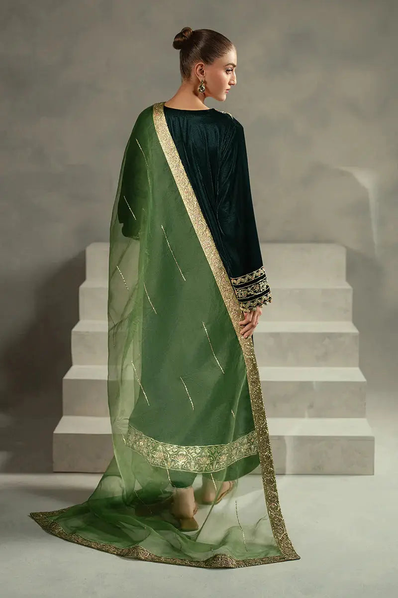 Rear angle of MUSHQ Ayren green velvet ensemble with sheer green dupatta and embroidered shirt, suited for elegant festive wear.