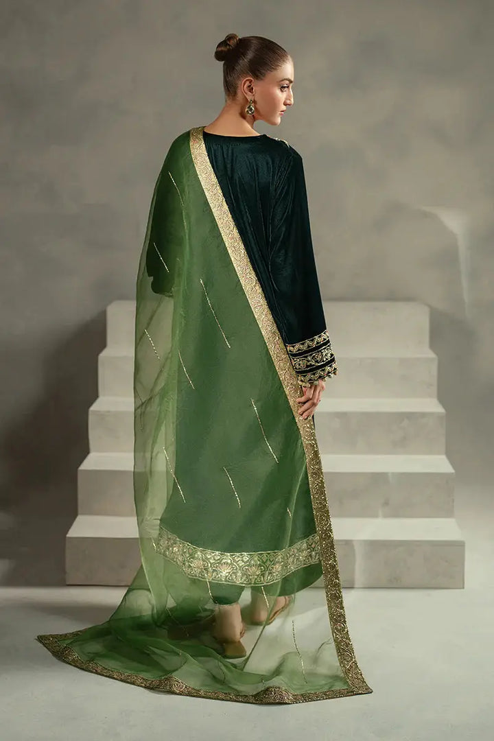 Rear angle of MUSHQ Ayren green velvet ensemble with sheer green dupatta and embroidered shirt, suited for elegant festive wear.