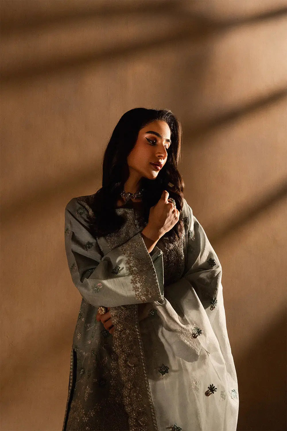 Side view of Maryum N Maria Evelyn women's 3-piece ensemble featuring embroidered shirt, matching pants, and sheer dupatta.