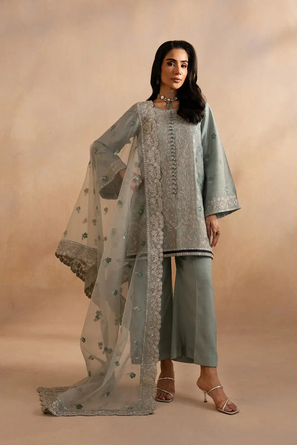 Close-up of Maryum N Maria Evelyn Pakistani outfit showcasing detailed embroidery on Korean silk shirt in soft blue-grey tone.