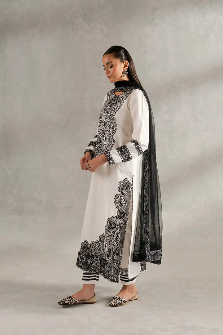Side profile of SIENNA - MS50417 Pakistani Dupatta Suit with floral black embroidery on white lawn shirt and striped cambric trousers.