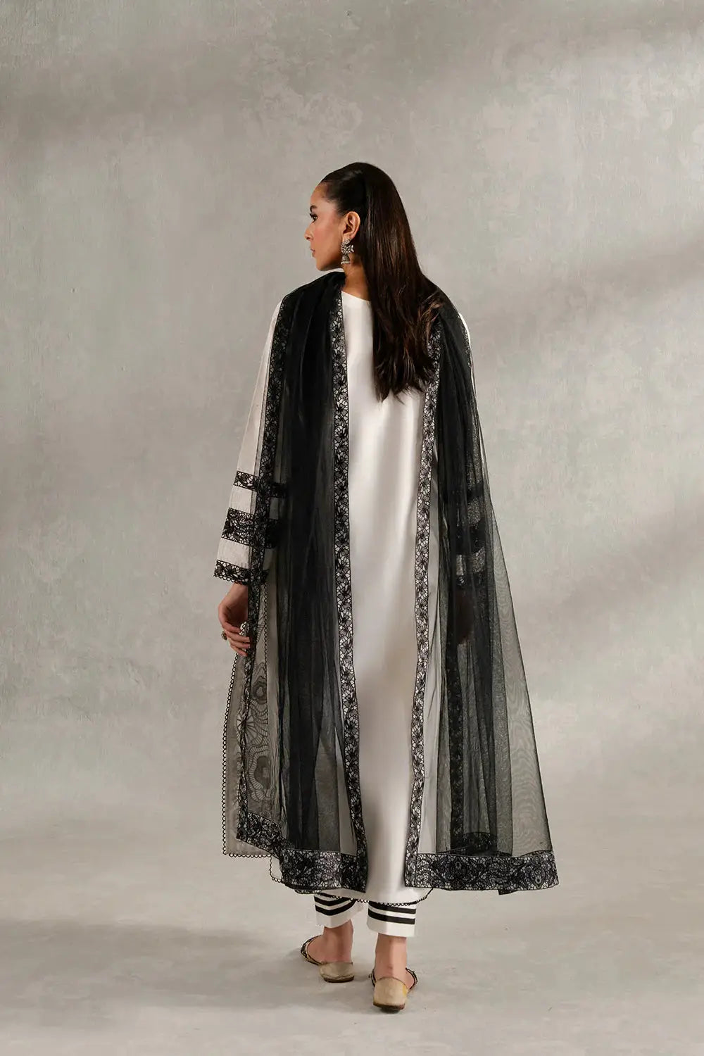 Back view of SIENNA - MS50417 Pakistani Dupatta Suit showing black embroidered net dupatta over a white cambric and lawn outfit.