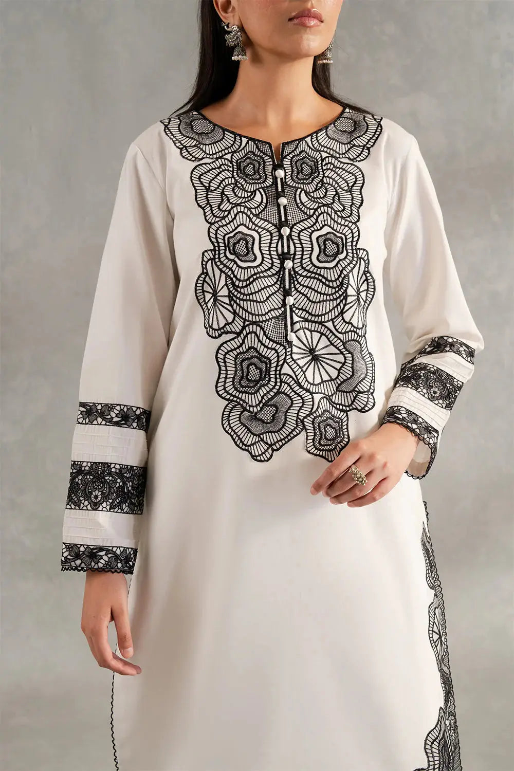 Close-up of SIENNA - MS50417 lawn shirt highlighting intricate black floral embroidery and button detailing on the neckline and sleeves.