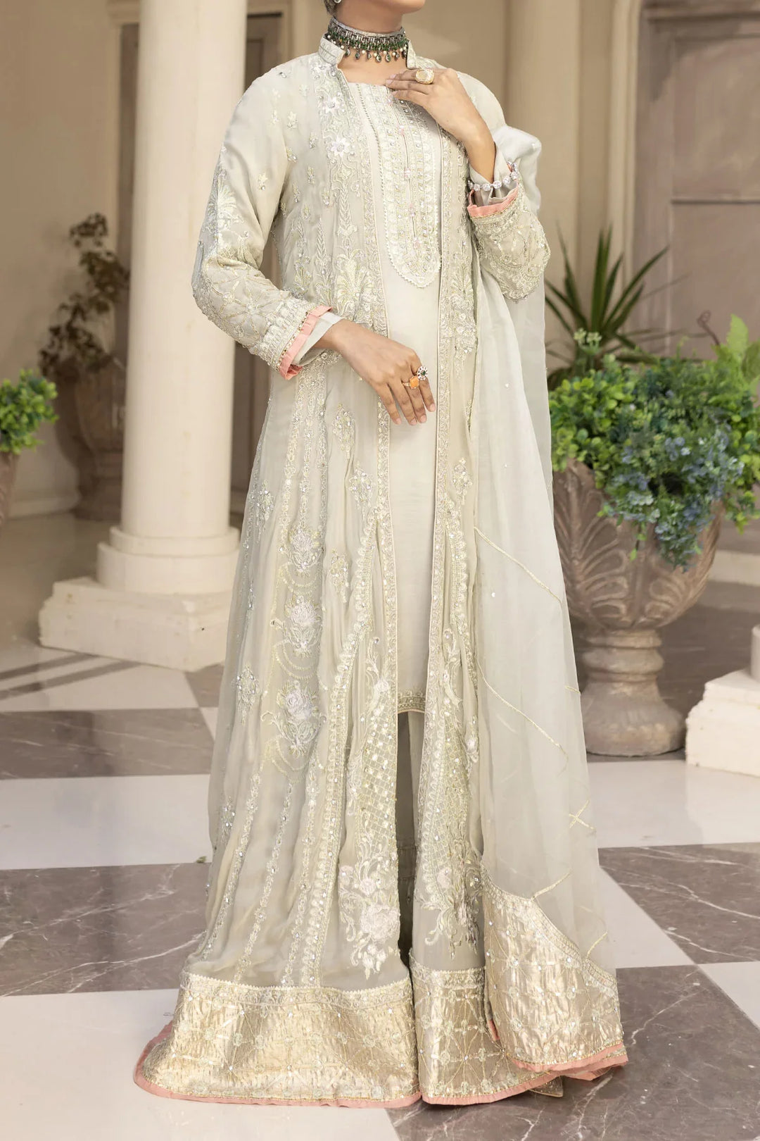 Full front view of light grey Pakistan gown dress woman with gold embroidered hem and sheer dupatta, elegant and festive.