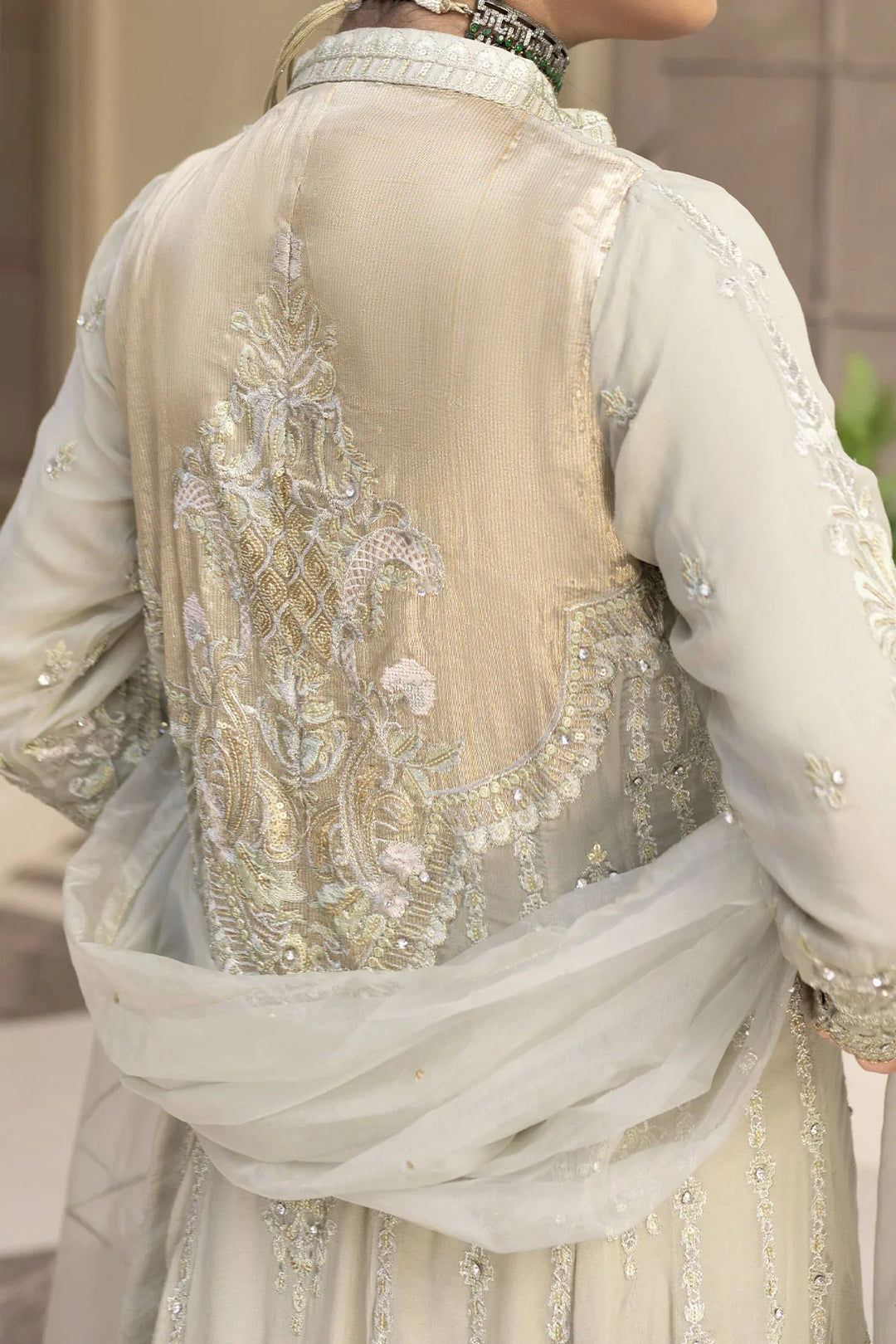 Back embroidery detail of light grey Pakistan gown dress woman, showcasing intricate craftsmanship and elegant design.