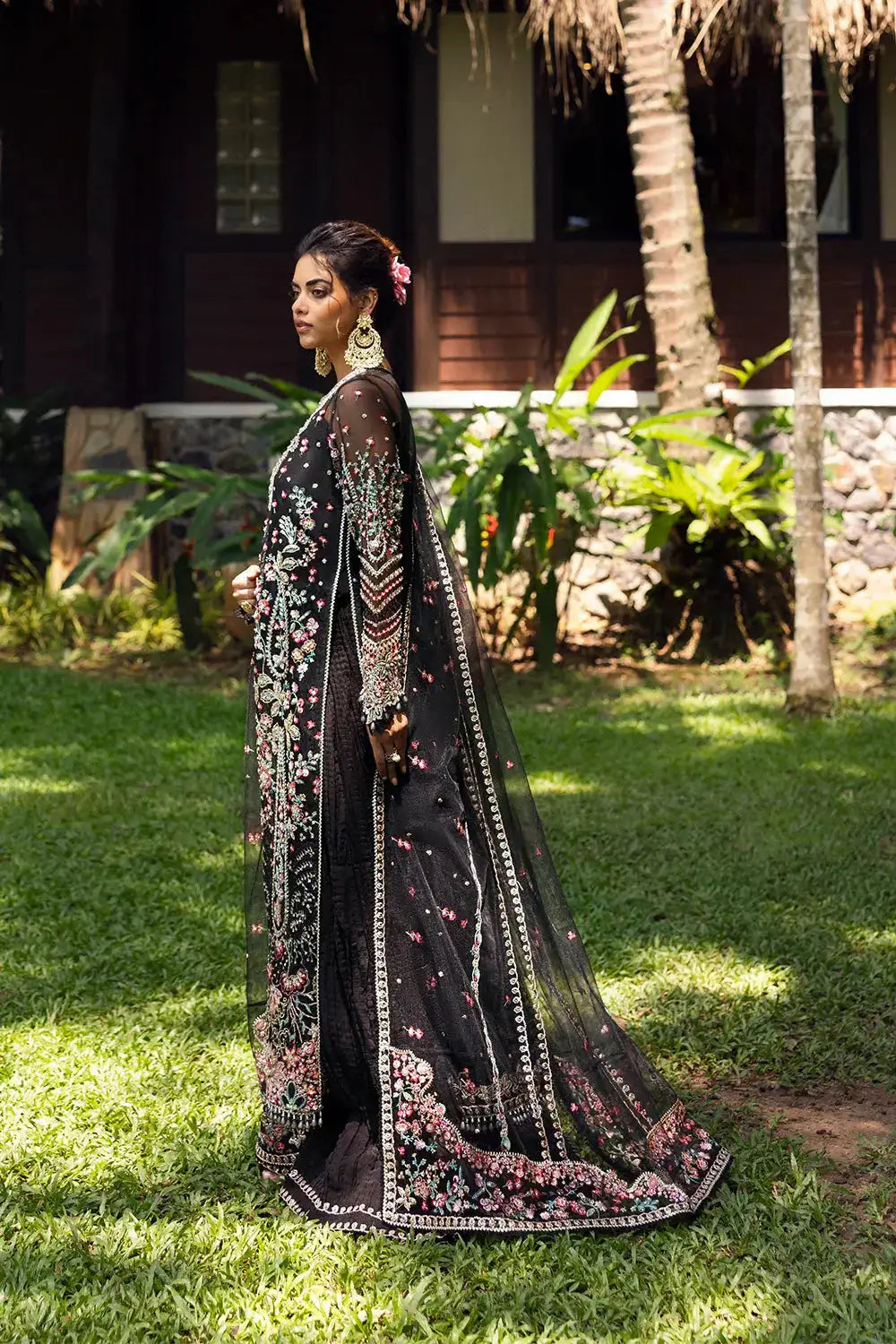 Side profile of AVINA-SRF25-02 - Saira Rizwan Embellished Organza Set with full-length dupatta and intricate threadwork on sleeves and bodice.