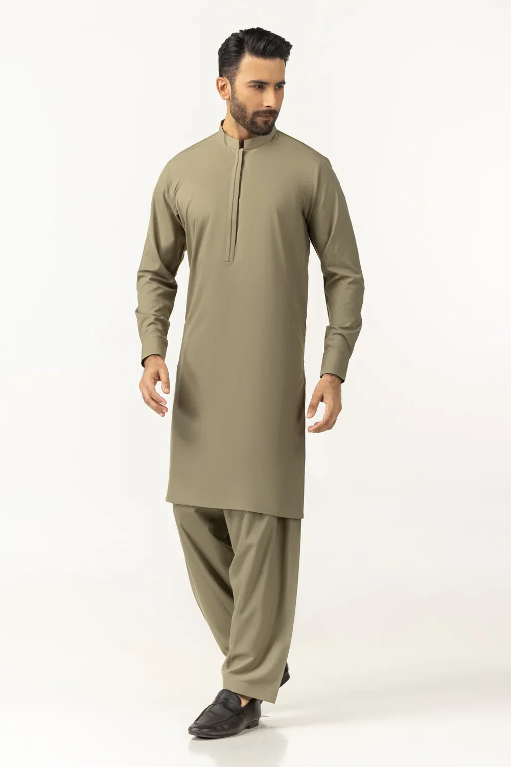 Man wearing a beige kurta with pants on a white background