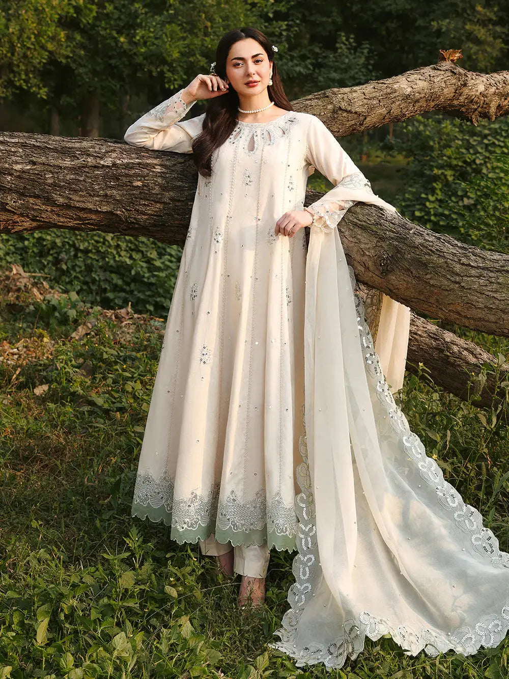 Elegant cream embroidered dress with dupatta, floral border, and lace detailing, suitable for formal wear