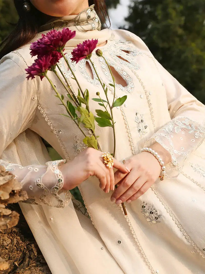 Close-up of embroidered dress with floral accessories