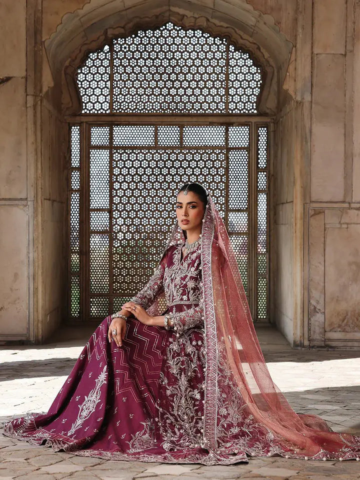 Close-up of bride in maroon embroidered dress with jewelry and sheer dupatta