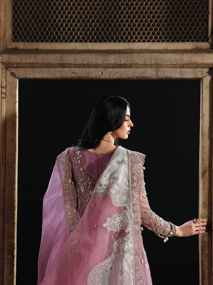 Side view of pink embroidered dress with detailed gold and silver embroidery, showcasing luxurious fabric and embellishments