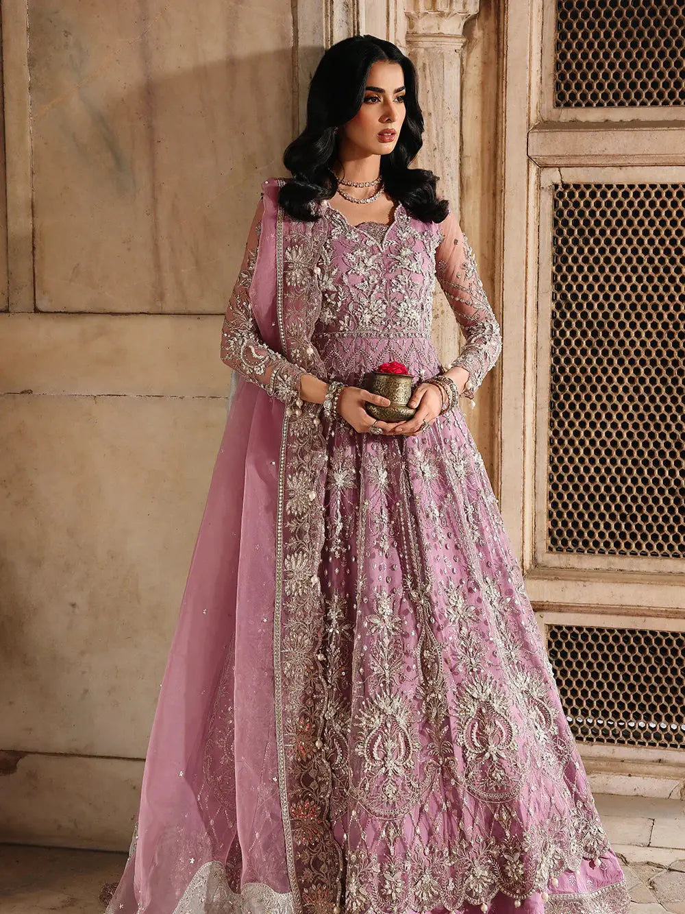Pink embroidered traditional dress with intricate silver embellishments, organza dupatta, and luxurious trousers for wedding attire