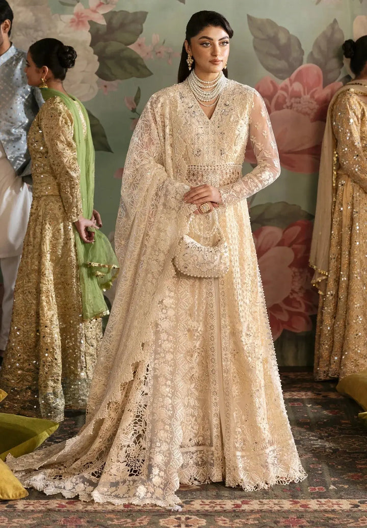 Wedding Formals - Pakistani Marriage Dress in ivory with intricate embroidery on net and organza, paired with raw-silk trousers and dupatta.