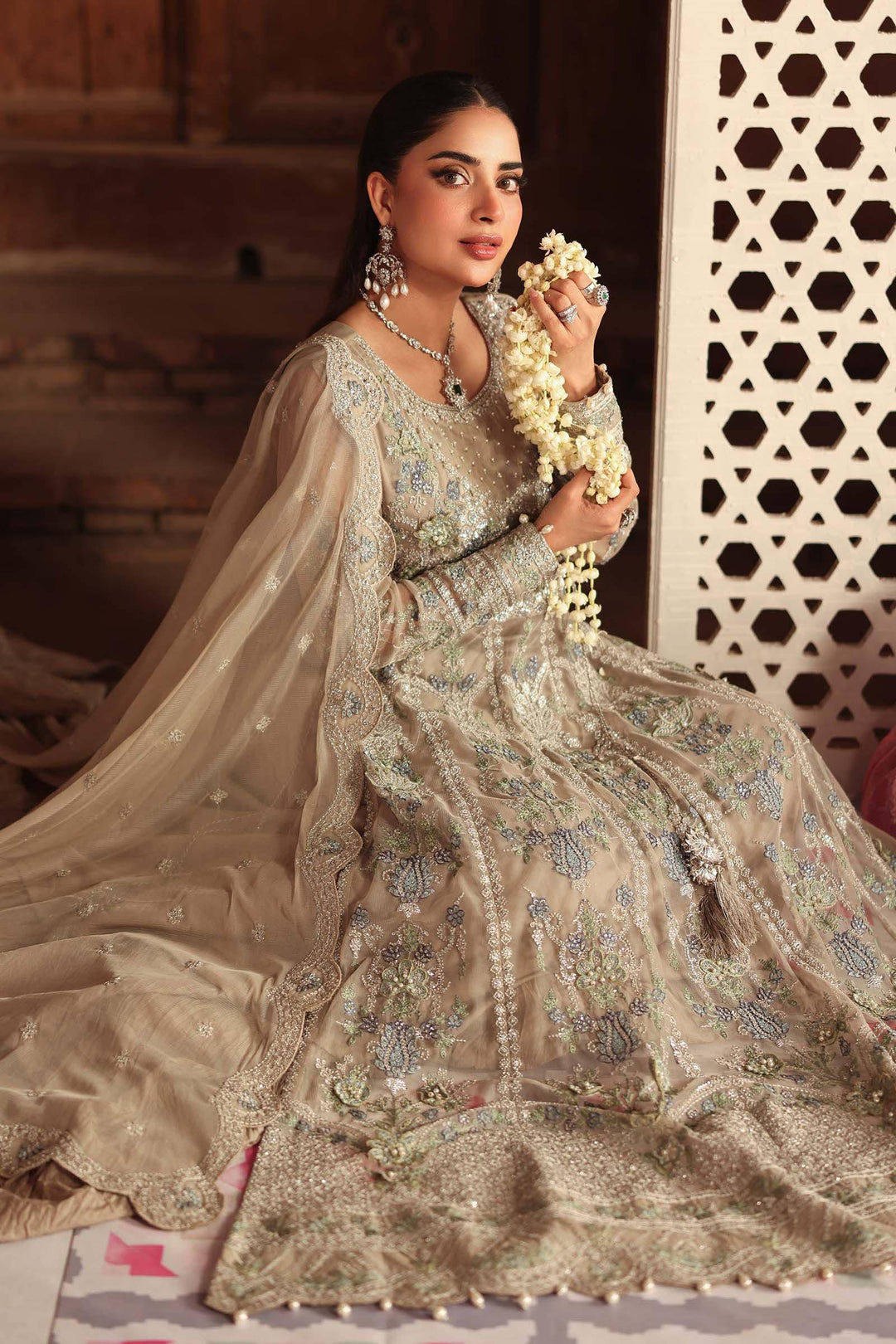 Seated pose in 3 Piece Embroidered Net Suit with detailed embroidery and soft net fabric, ideal for traditional wedding attire.