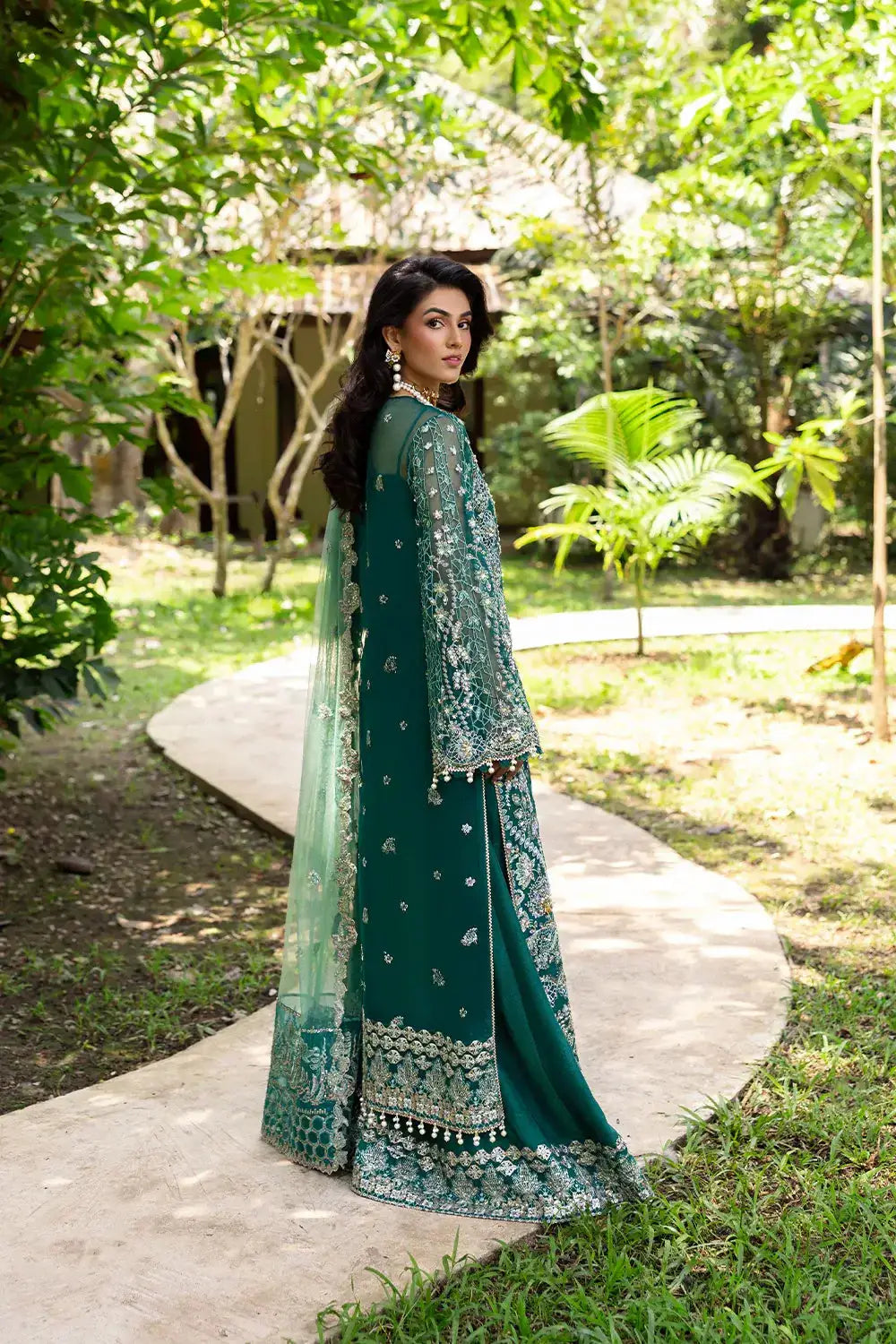 Back view of KIANA-SRF25-04 green embroidered dress by Saira Rizwan, showcasing detailed embellishments and flowing net dupatta.