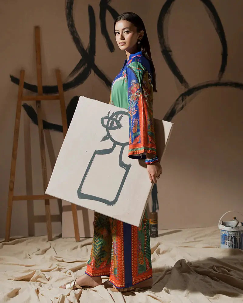 Model holding canvas while wearing 2 Piece Outfit EA-21, a printed raw silk co-ord set with artistic flair and bold multicolor design.