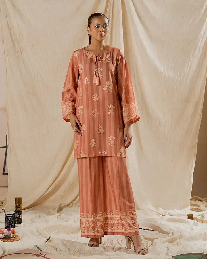 Front pose of 2 PIECE OUTFIT - Printed Raw Silk Co-ord | Statement Wear in peach with tassel neckline and ethnic-inspired prints.