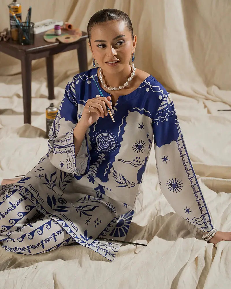 Model seated in the EA-17 Printed Co-ord Set, showcasing the detailed raw silk shirt design and relaxed fit, ideal for chic and elegant wear.