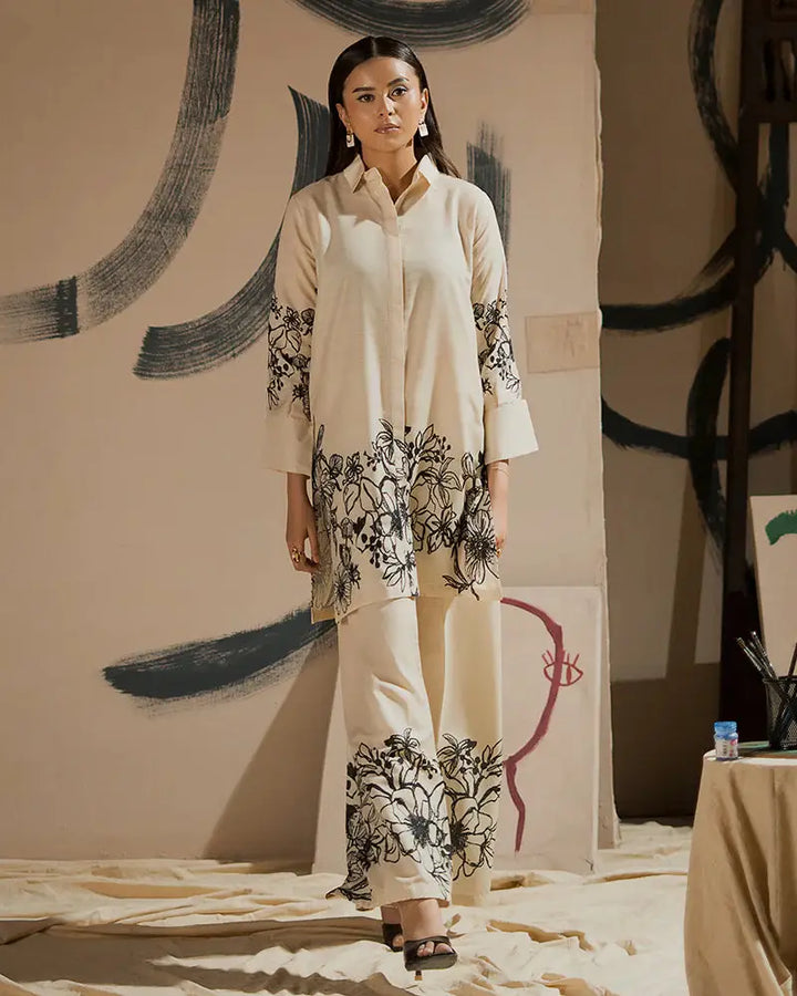 EA-19 printed outfit in raw silk featuring black floral designs on cream shirt and bottom, ideal Pakistani clothes for Eid gatherings.