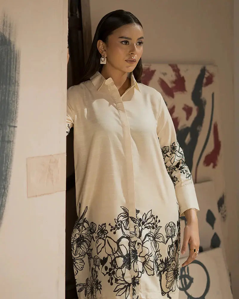 Close-up of EA-19 printed raw silk outfit with intricate black floral patterns, a stylish Pakistani co-ord set for Eid celebrations.