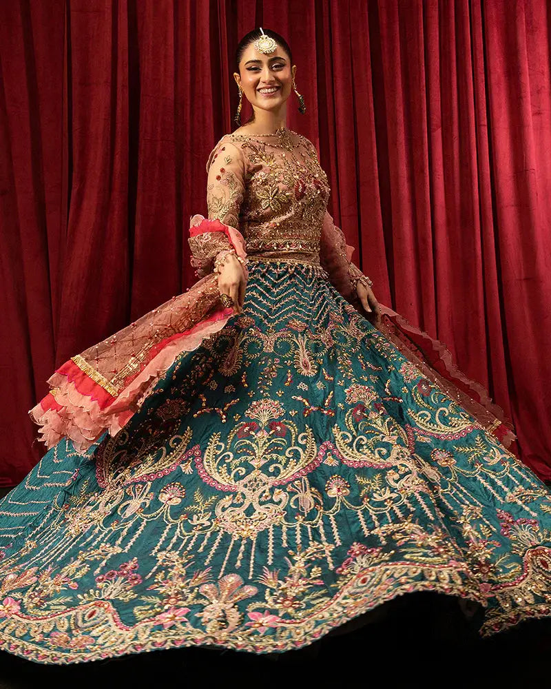 Model twirling in AROOSH FAANA AR-97-3500 lehenga set with vibrant teal and gold embroidery, perfect for weddings and celebrations.