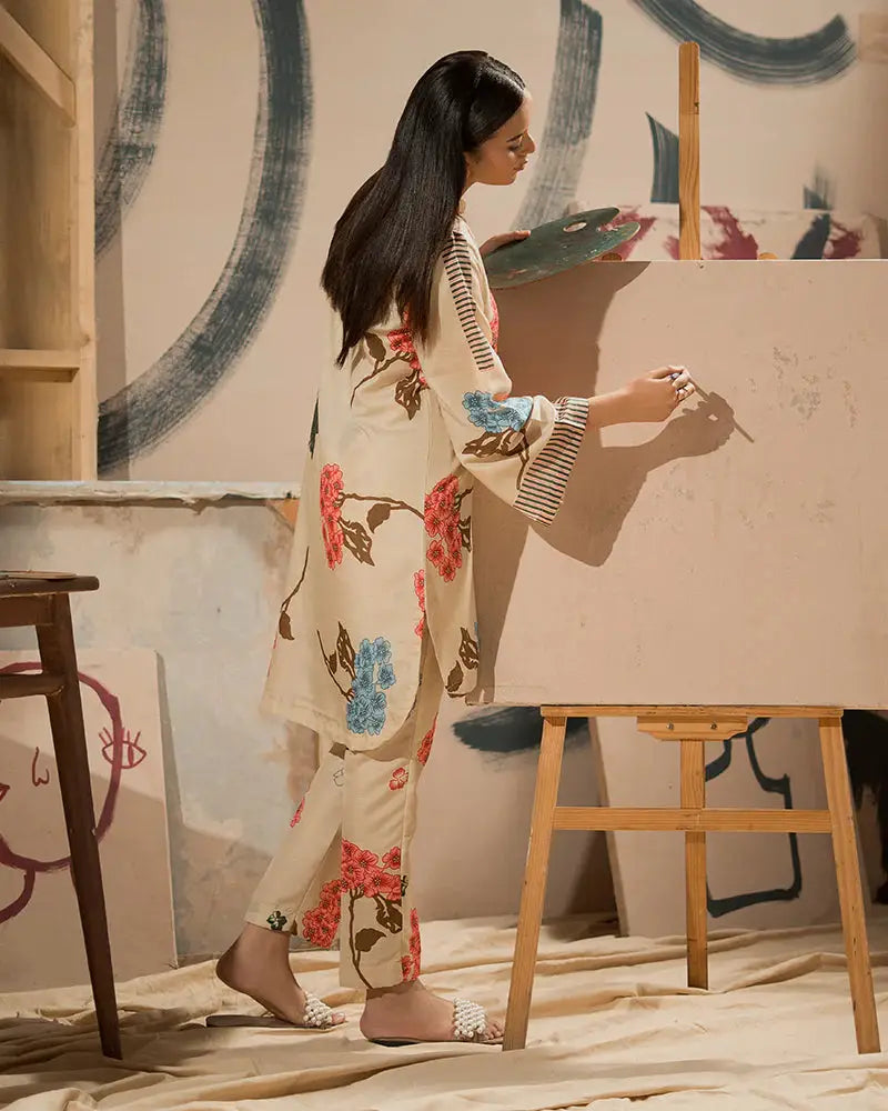 Back view of Printed Raw Silk Co-ord Set | 2 Piece Outfit in beige with floral patterns, showcasing relaxed fit and artistic setting. Shop Pakistani outfits.