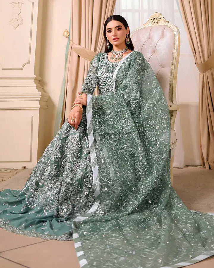 AROOSH Organza Maxi - Pakistani Asian Clothes | Embellished Dress styled with luxurious dupatta and seated pose highlighting fabric texture.