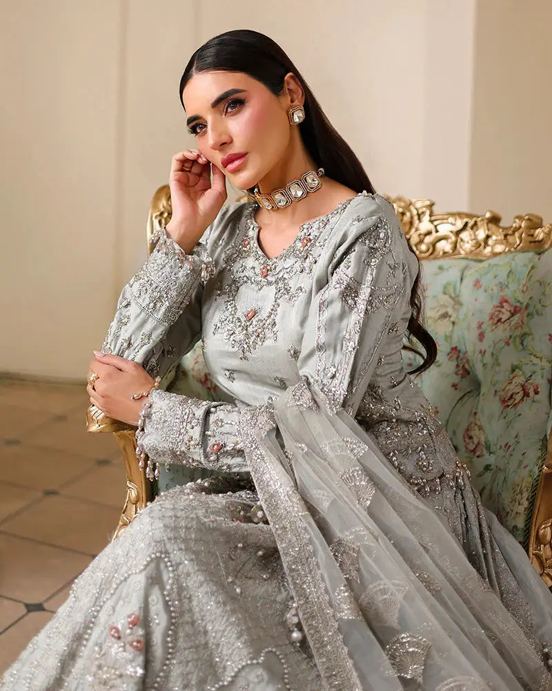 Close-up of AROOSH WEDDING WEAR bridal Raw Silk Choli showcasing pearl details, naqshi work, and elegant neckline embroidery with matching jewelry.