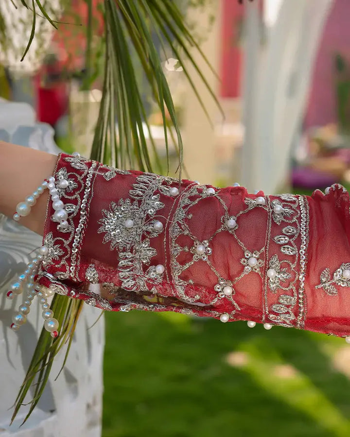 Detailed sleeve embroidery of AROOSH Designer Pakistani Party Wear with pearls and sequins on red organza, ideal for weddings.