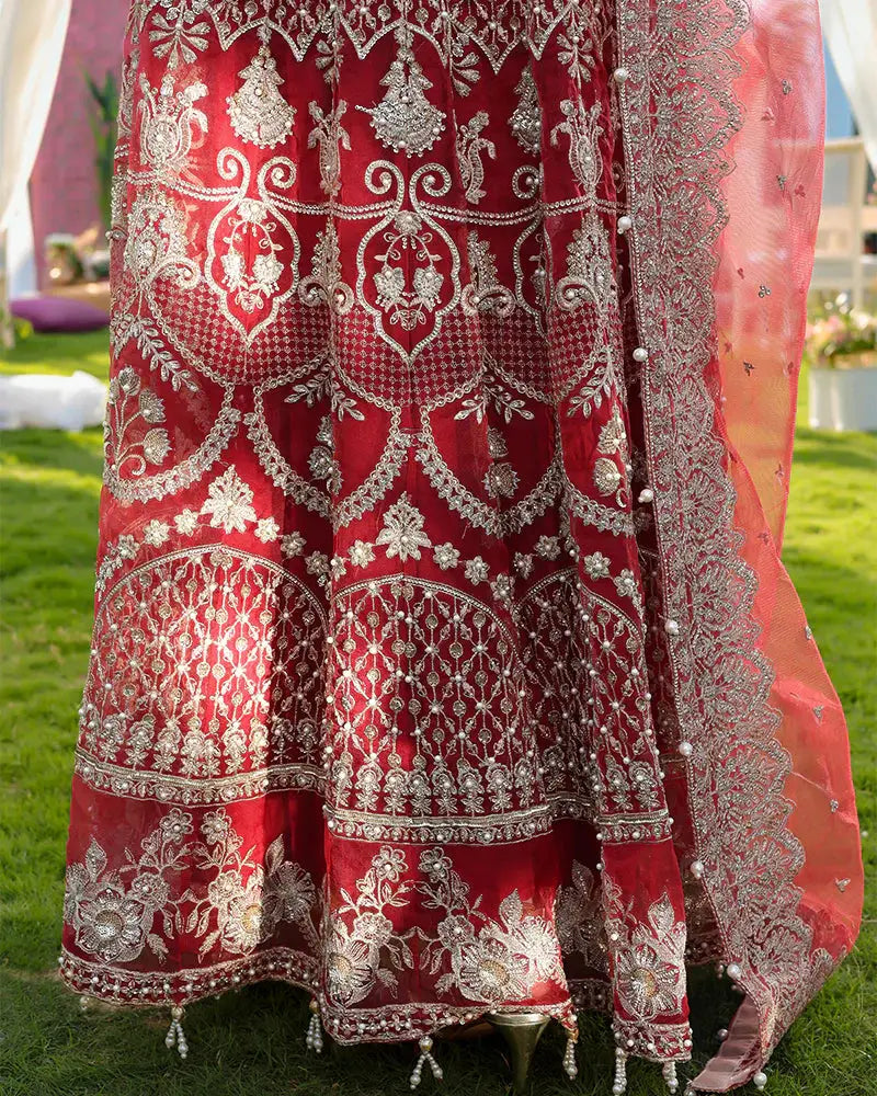 Lower skirt embroidery of AROOSH Wedding Wear in red organza with silver threadwork and sequin patterns, perfect for party attire.